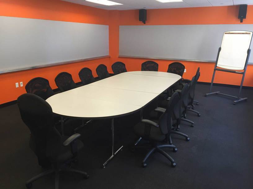 conf1-NYC Focus Group Room with conference table, and orange walls with push pin panels.