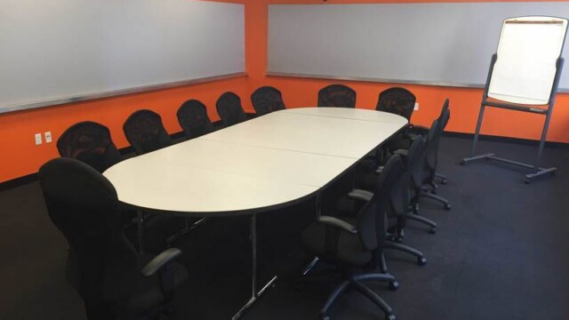 Focus Group Room with conference table, and orange walls with push pin panels.